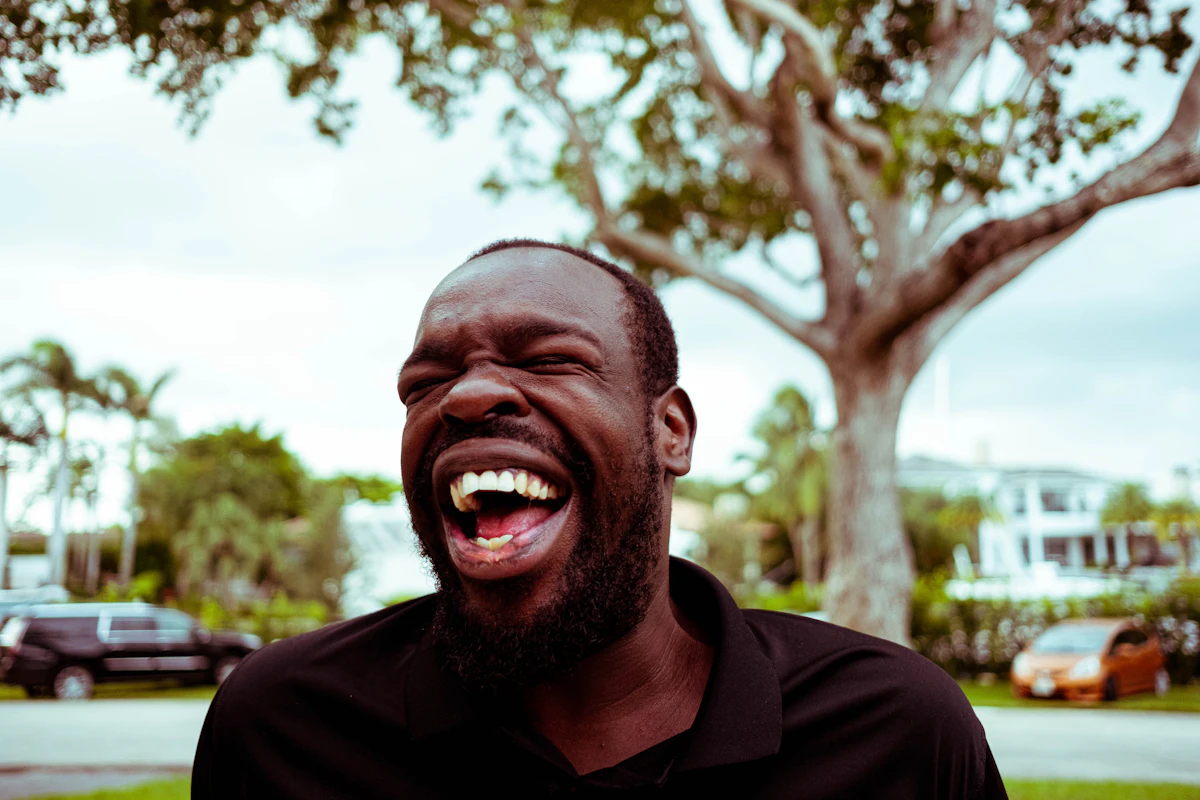 A man laughing outdoors