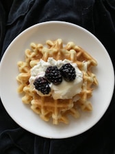 white ceramic plate with black and white berries