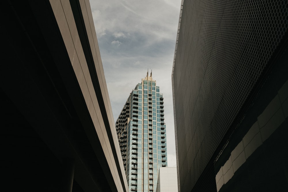 white and gray concrete building under white clouds during daytime