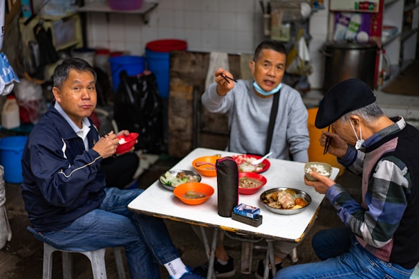 The husband and sons trying out a quirky local food during a travel adventure.