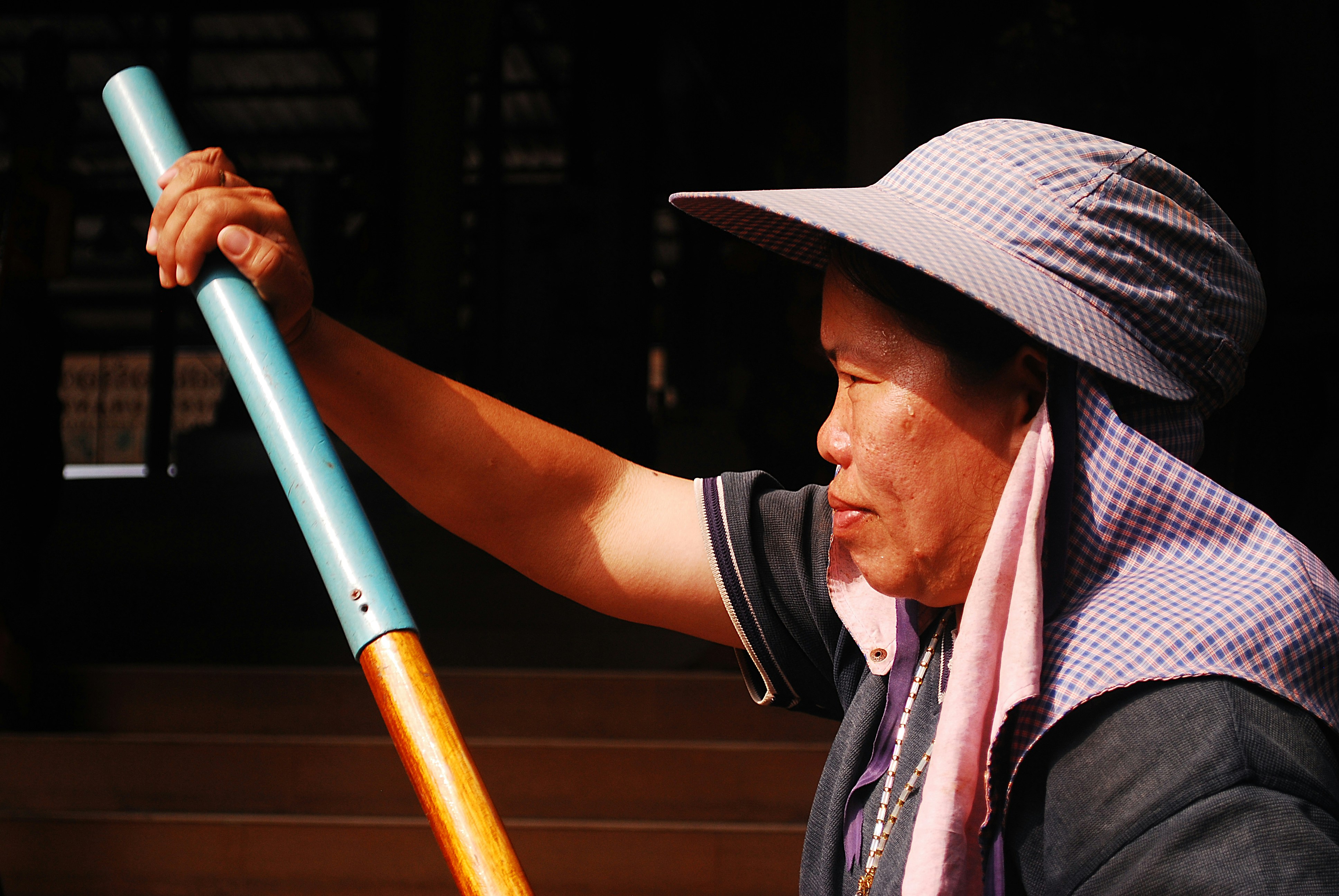 man in brown cowboy hat holding blue metal bar