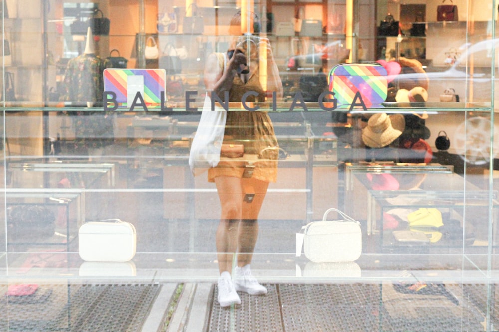 woman in white dress walking on street during daytime