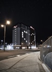 Night view of a hotel illuminated with warm lights against a starry sky