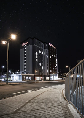 Modern hotel exterior illuminated at night near Haram.