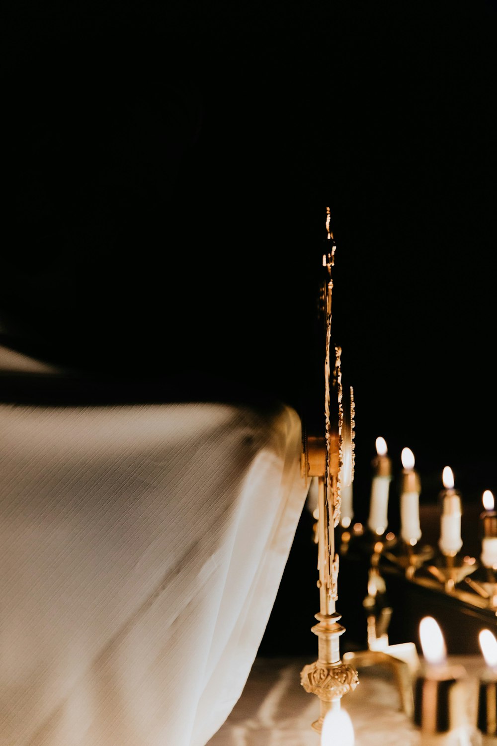 white textile with gold cross