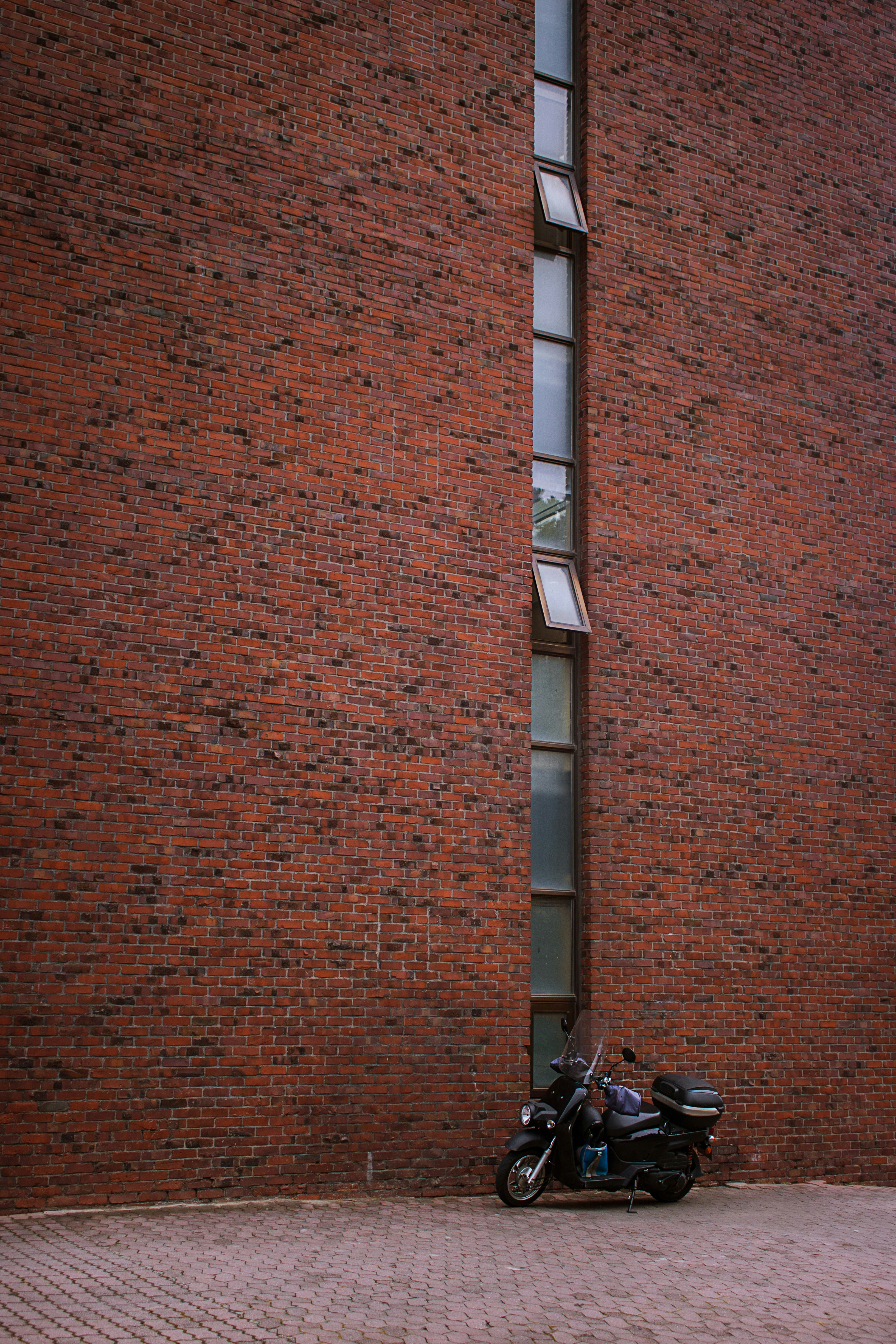 brown brick wall with black bicycle