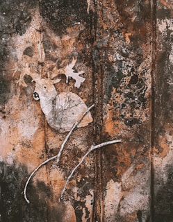 A detailed shot of a hunting-themed t-shirt with an intricate deer design on a rustic wooden background.