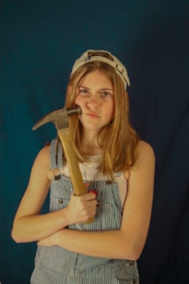 woman in black tank top holding brown wooden handle sword