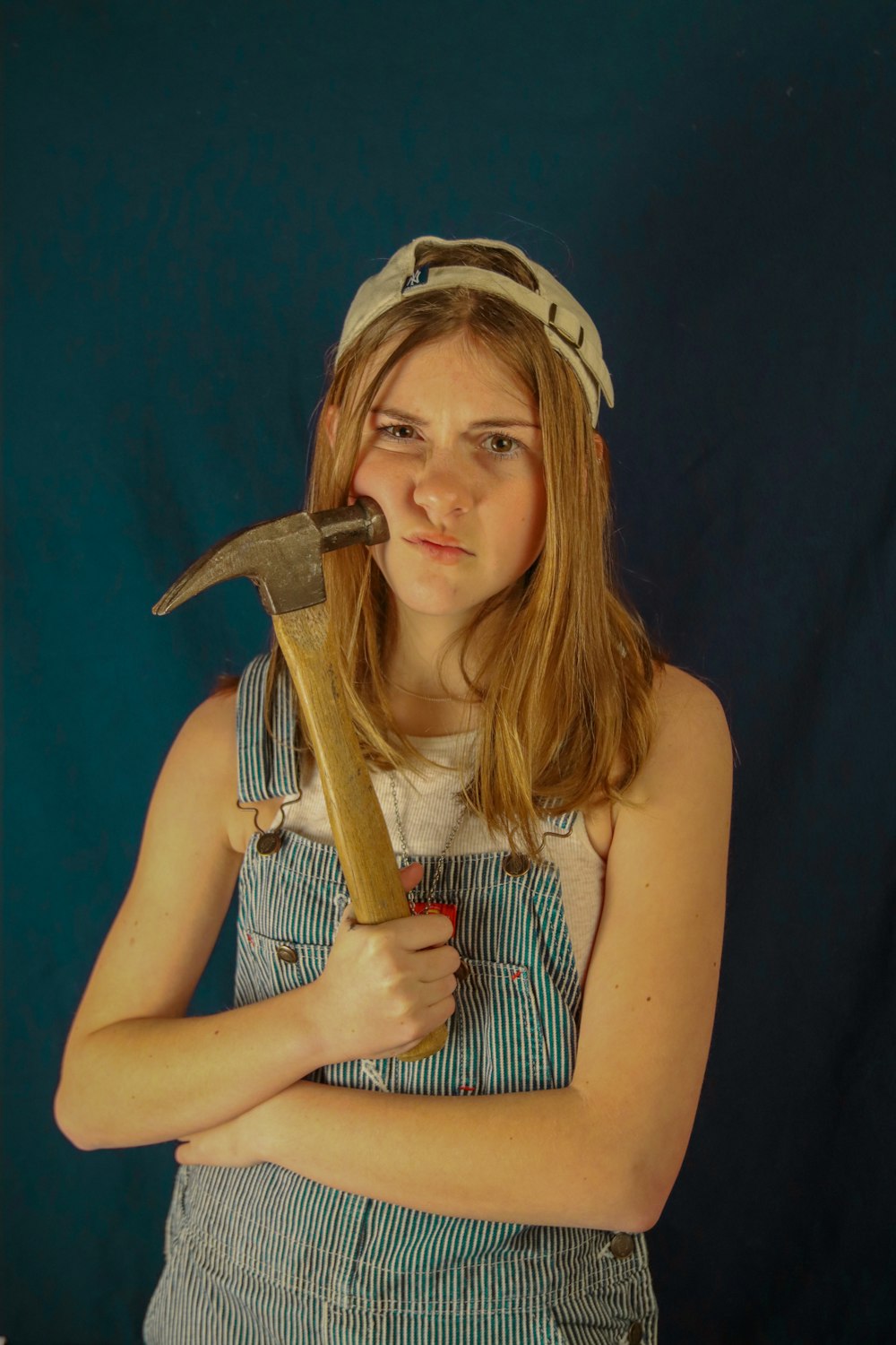 woman in black tank top holding brown wooden handle sword