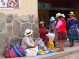 A group of women proudly showcasing their handcrafted goods at a local market.