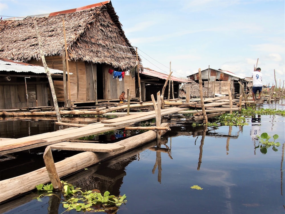 brown wooden house on body of water during daytime