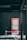 A red sign labeled 'TOKIWASO MANGA MAP' stands against a dark wall. Snow falls gently, covering the ground and creating a wintry scene. A red and white traffic cone and barrier are also visible, partially covered in snow. The scene suggests a cold, outdoor setting.