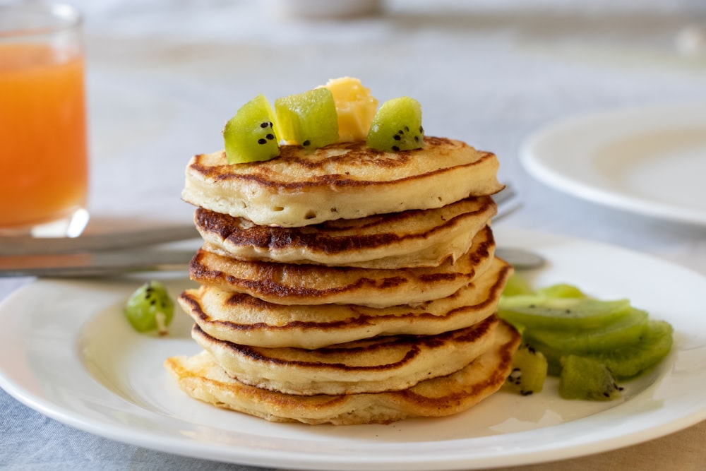 brown pancakes with sliced lemon on white ceramic plate