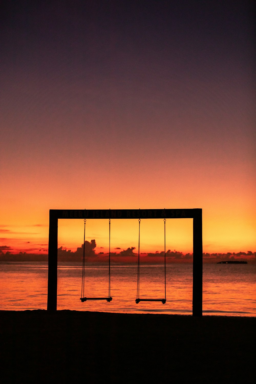 silhouette of a person standing on a beach during sunset