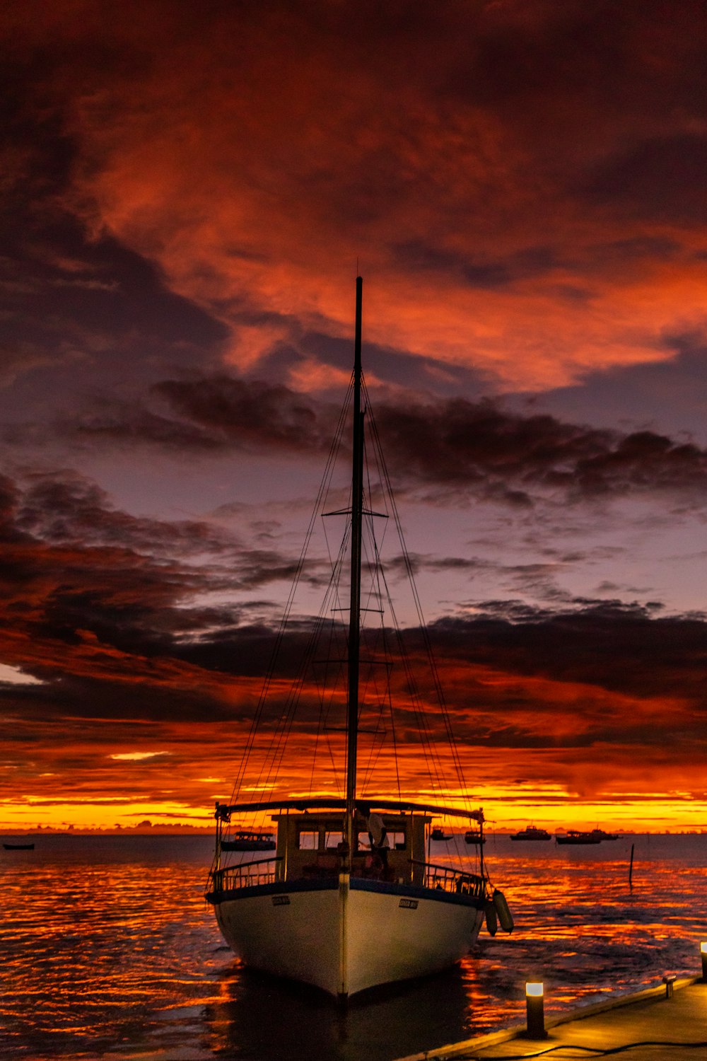 silhouette of boat on sea during sunset