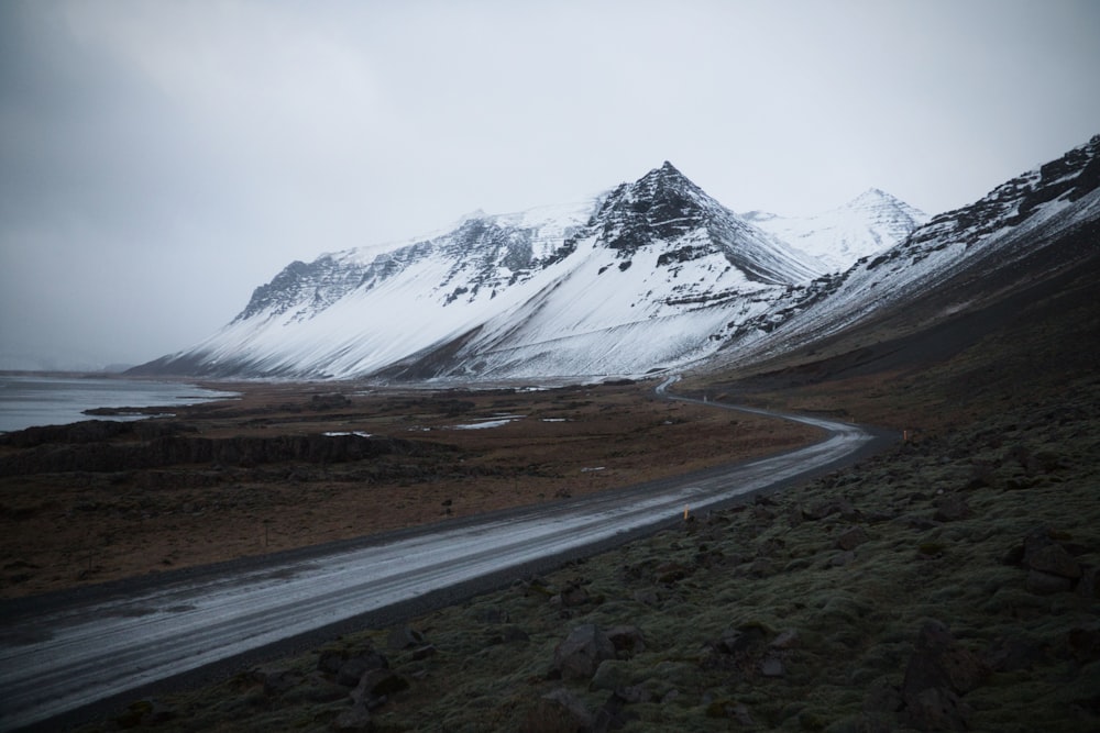 gray road near snow covered mountain