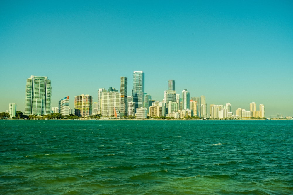 city skyline across body of water during daytime