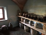 Artisanal koji fermentation jars lined up in a rustic Chilean kitchen