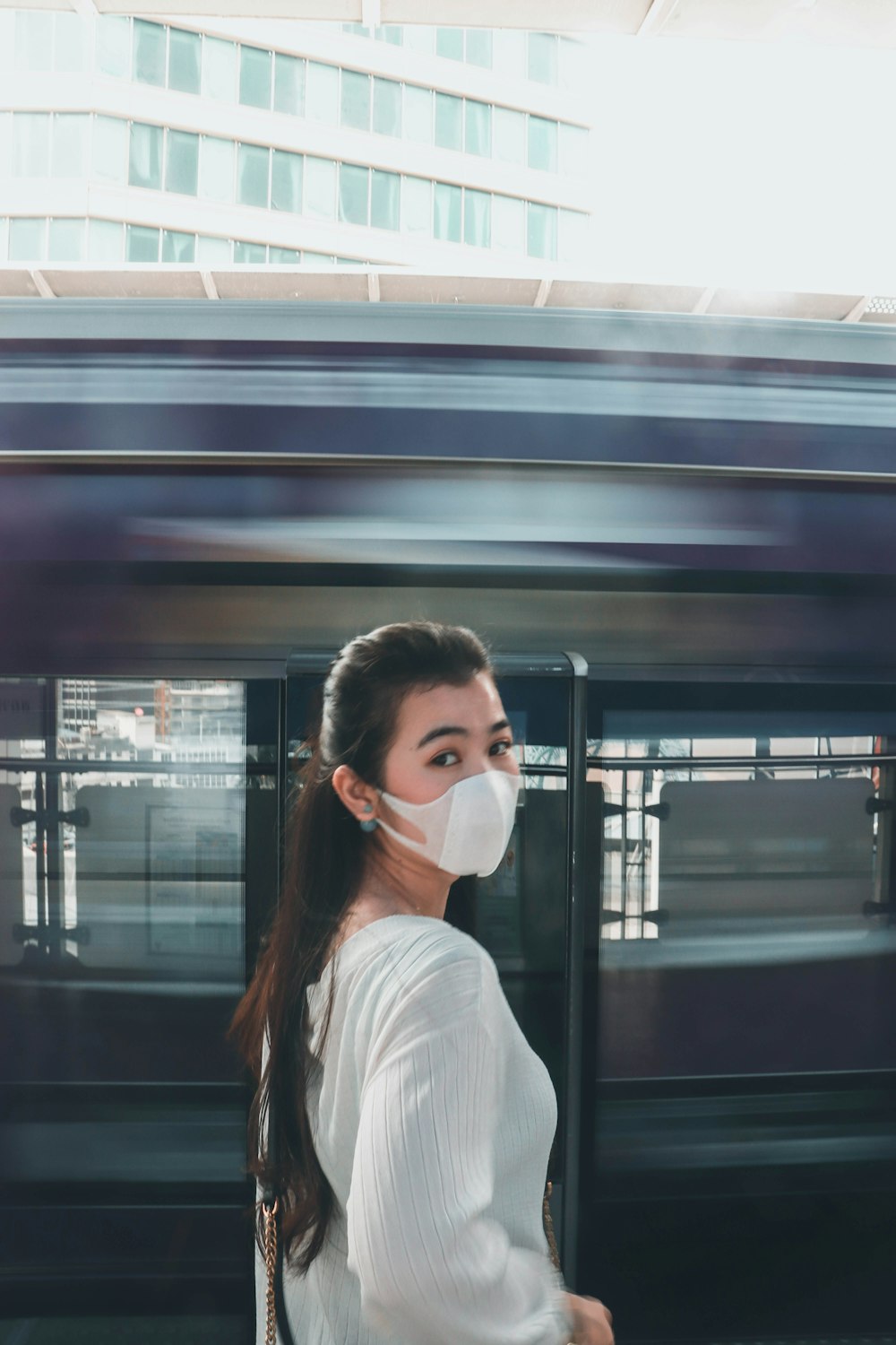 woman in white shirt wearing white face mask