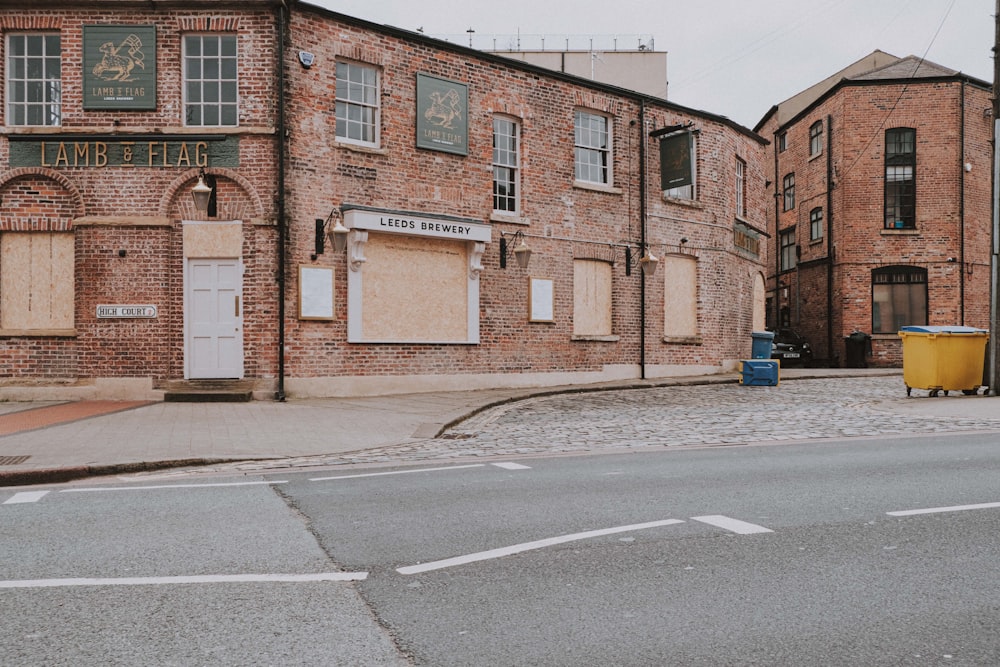 brown brick building beside road during daytime