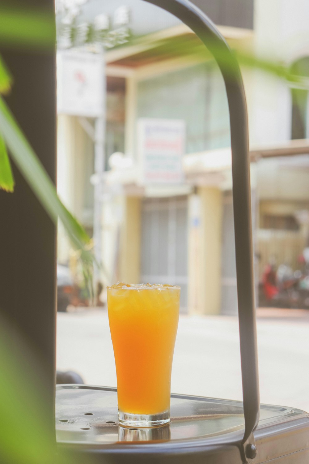 orange juice in clear drinking glass