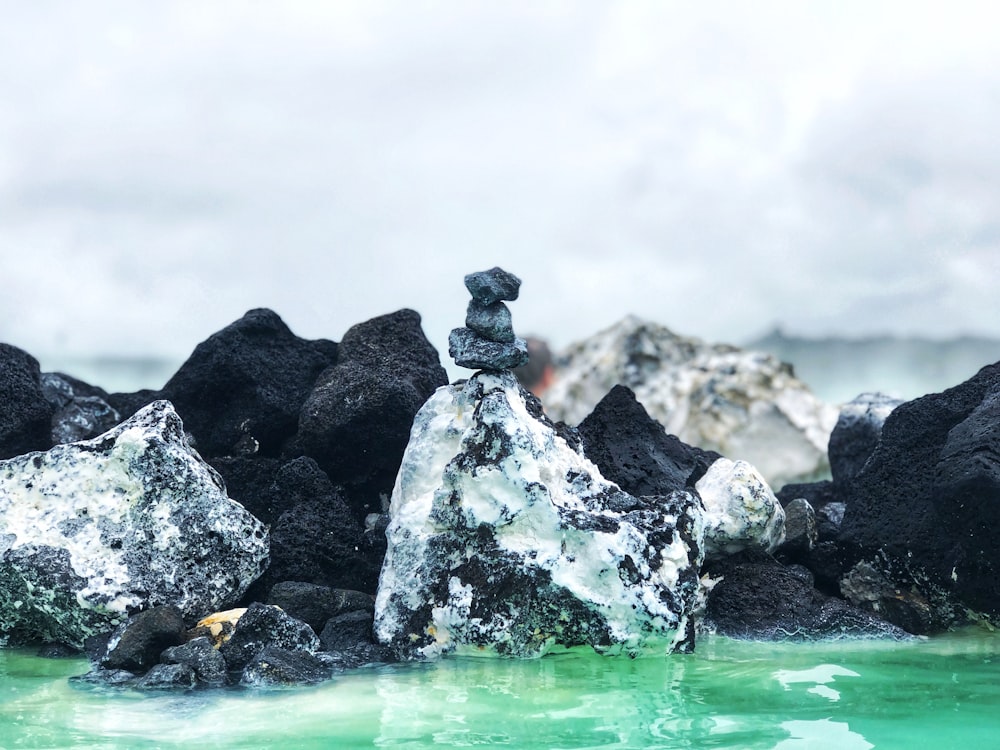 gray and black stone on water