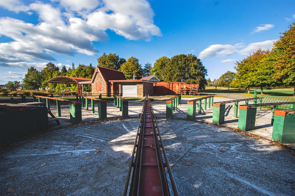 brown wooden houses near green trees under blue sky during daytime