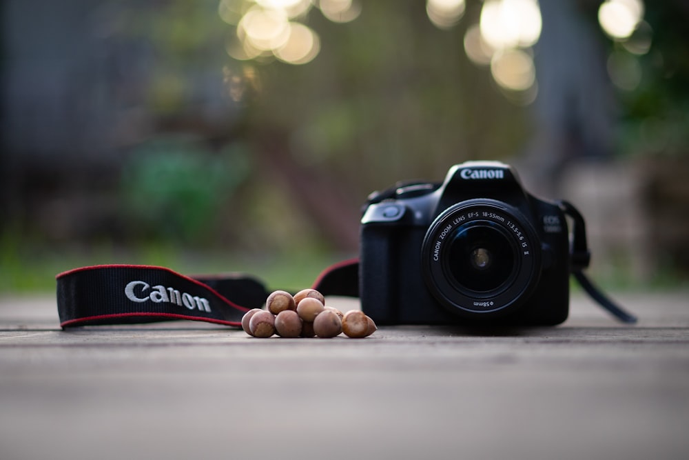 black nikon dslr camera on gray pavement