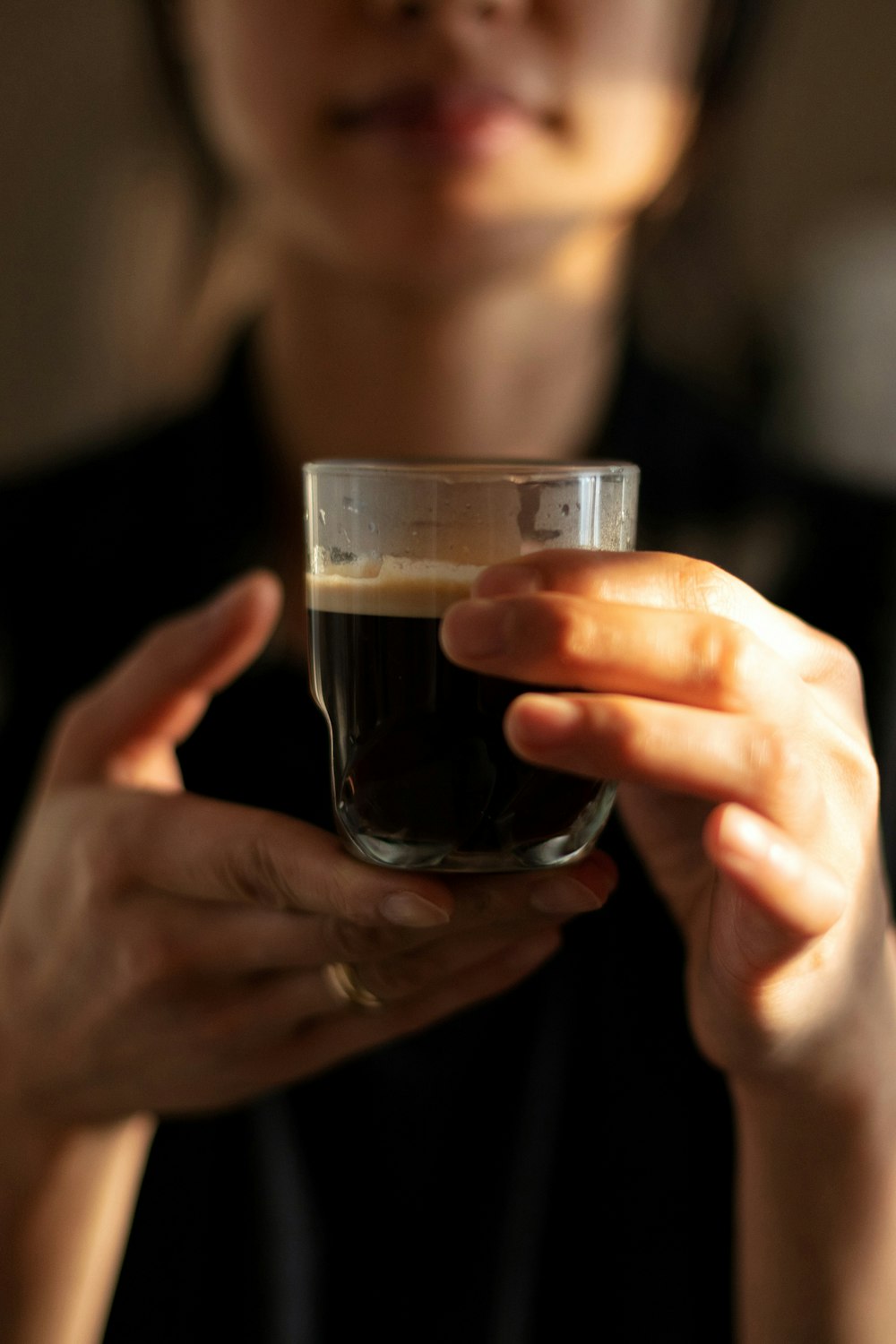 person holding clear drinking glass