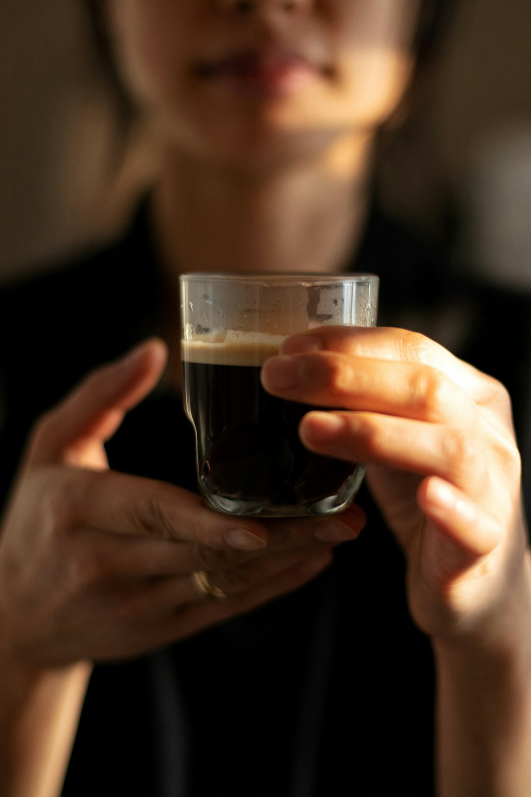 person holding clear drinking glass