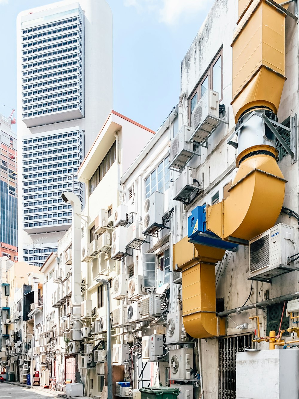 yellow and black outdoor lamp on white concrete building during daytime