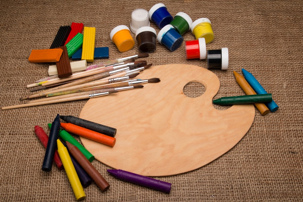 assorted color pen on brown wooden table