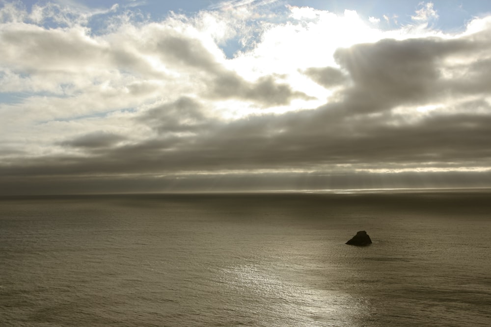 body of water under cloudy sky during daytime