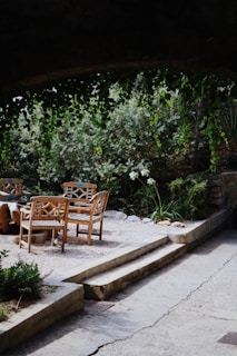 An outdoor meeting area where community members discuss plans around a wooden table.