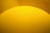 yellow round plastic on brown wooden table