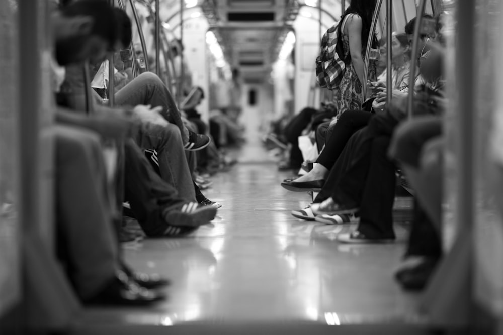 people sitting on floor in grayscale photography