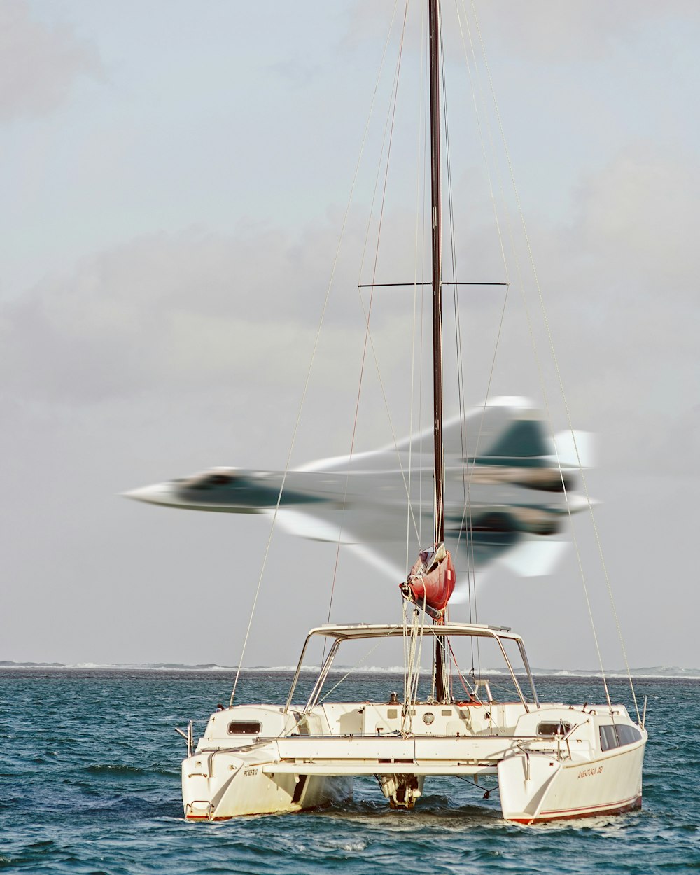 person in red shirt and white shorts sitting on white boat during daytime