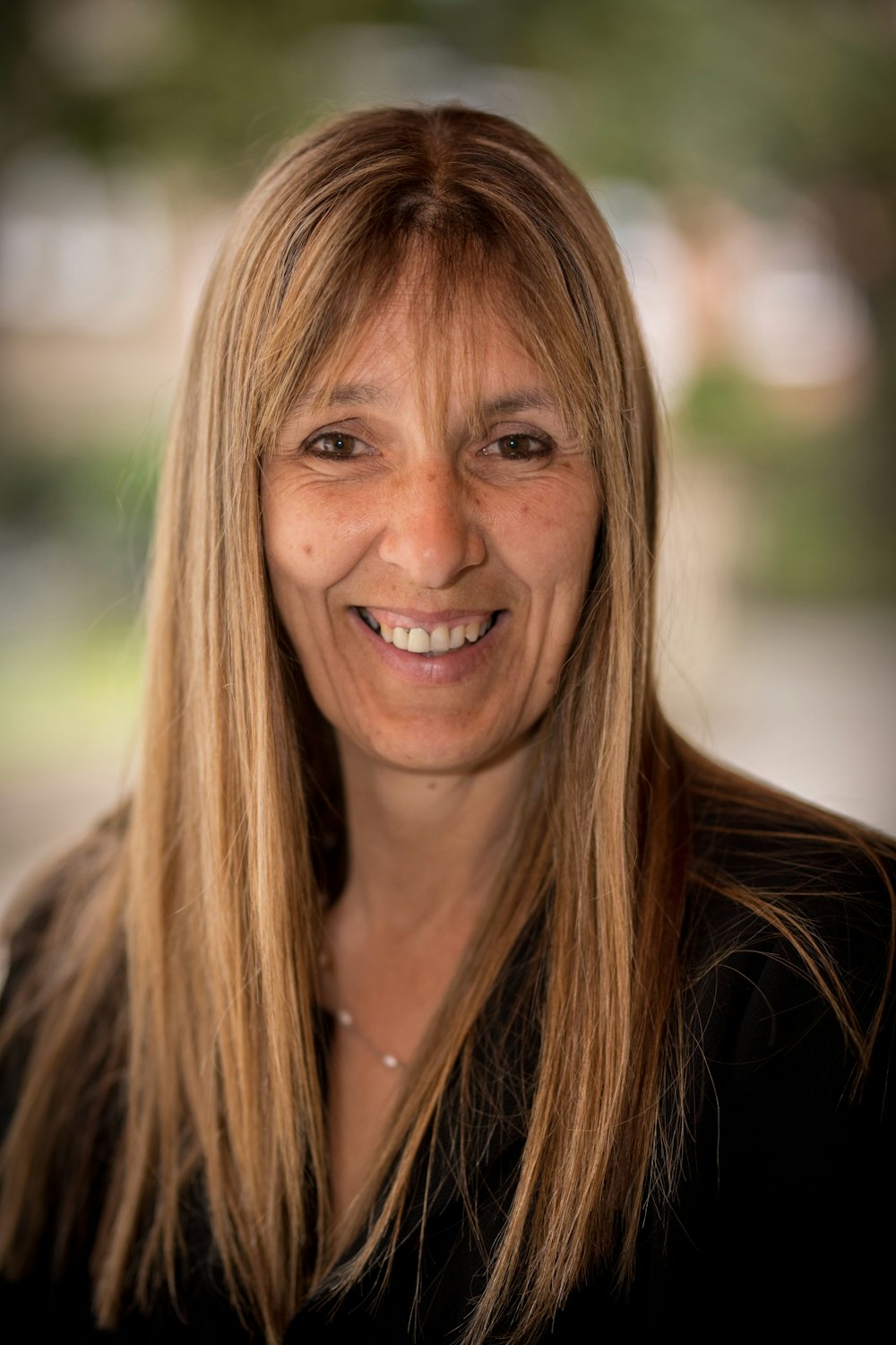 smiling woman in black blazer