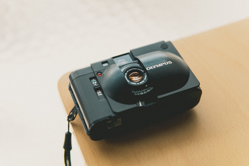 black nikon dslr camera on brown wooden table