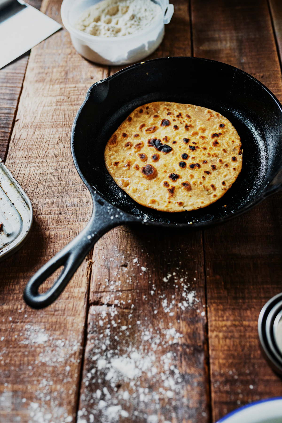 Cast iron fry pan on a wooden kitchen table