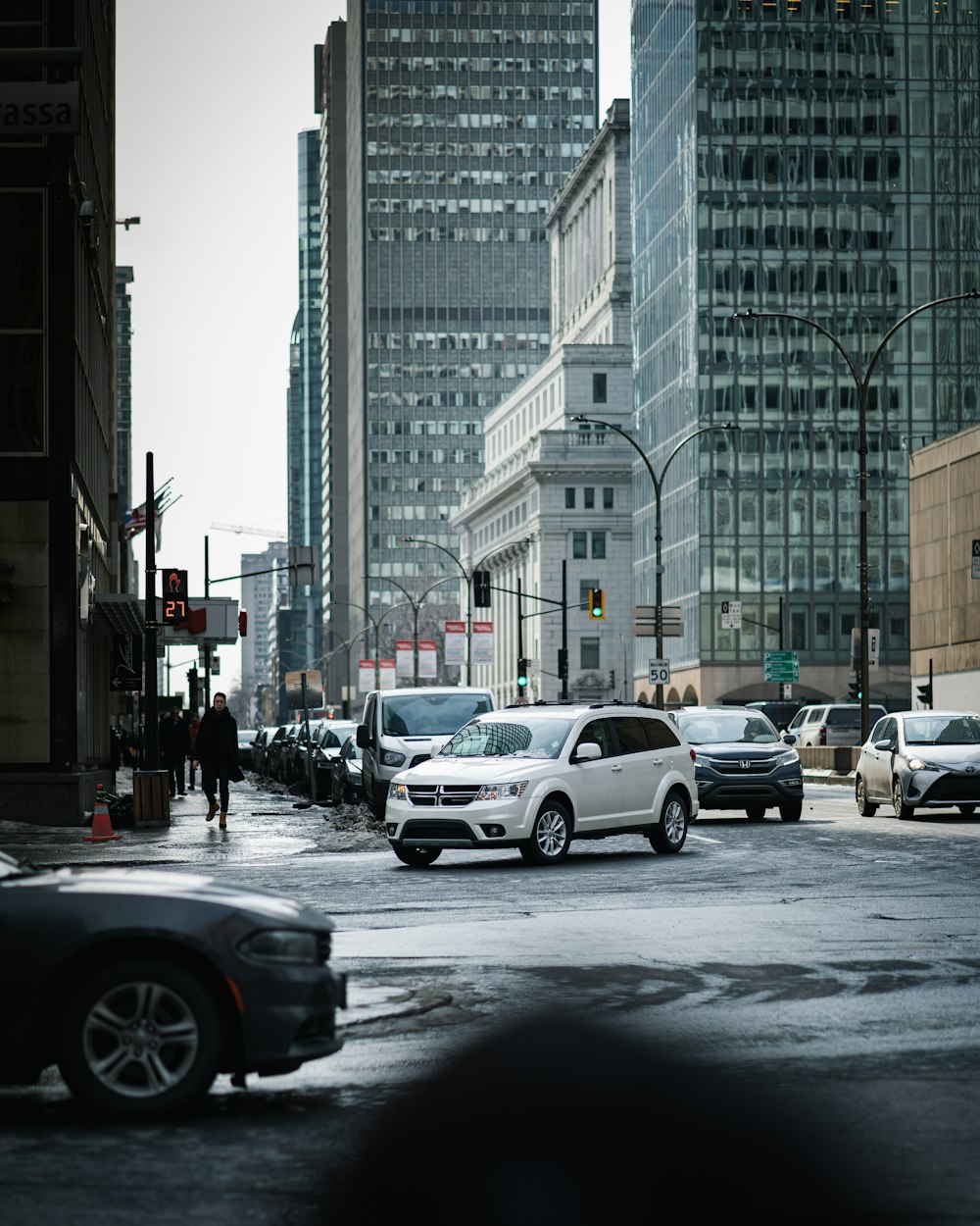 cars on road near high rise buildings during daytime