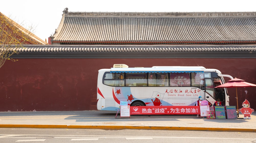 red and white bus on road during daytime