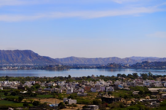 city near body of water during daytime in Pushkar India
