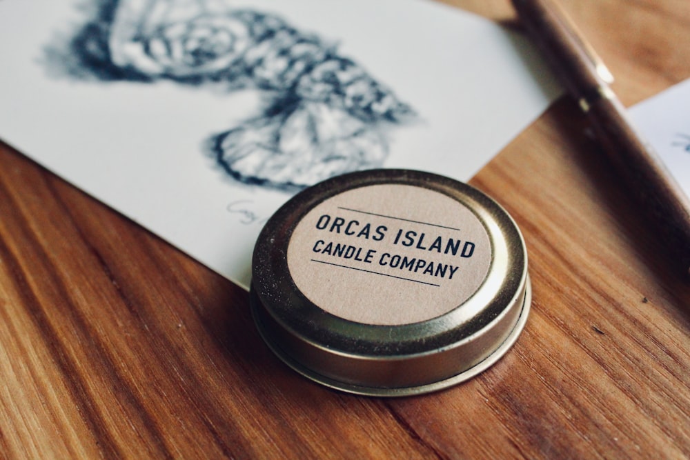 black and white round container on brown wooden table