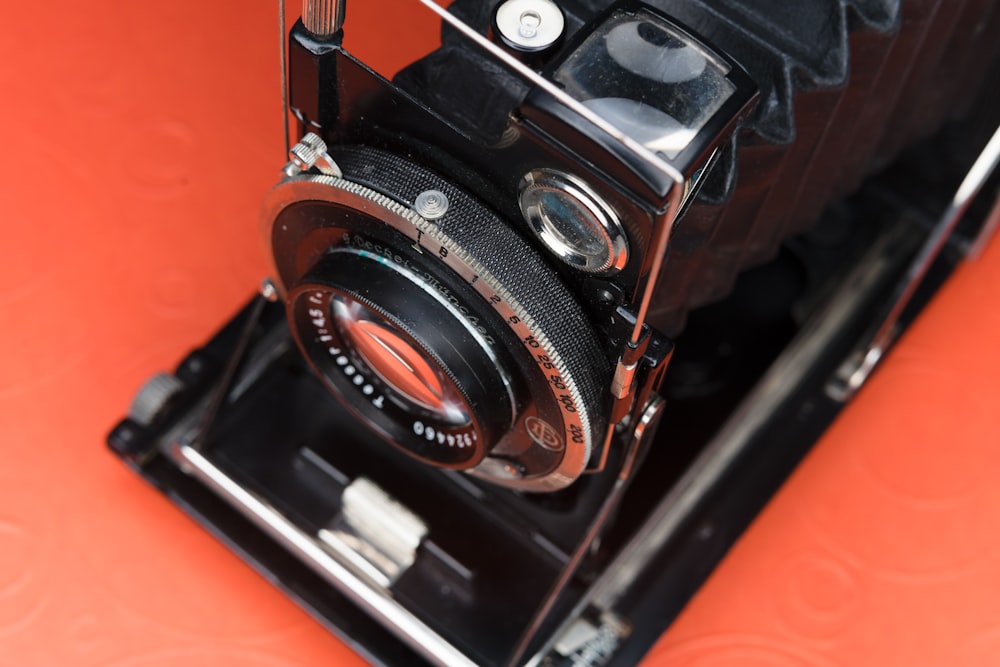 black and silver camera on black table