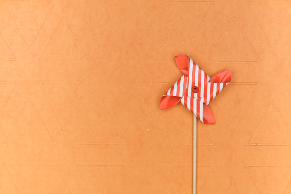 red and white ribbon on brown surface