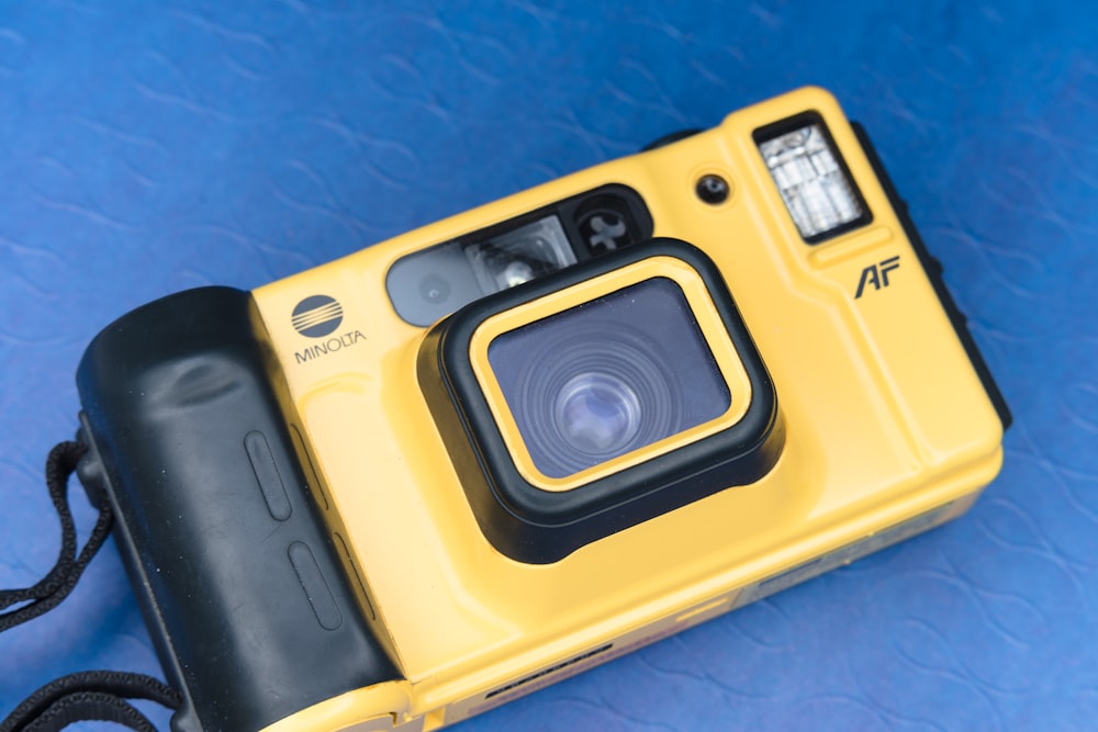 yellow and black point and shoot camera