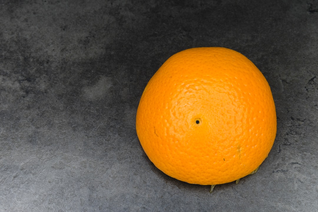 orange fruit on gray textile