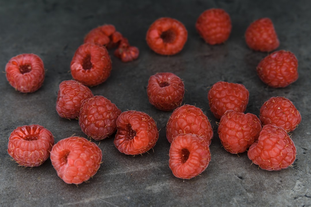 red round fruits on gray textile