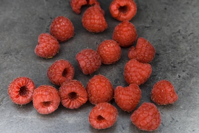 red round fruits on gray surface intensive zoom background